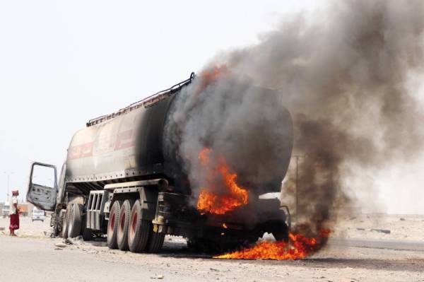 FILE PHOTO: A man stands next to an oil tanker truck set ablaze during recent clashes between Yemeni southern separatists and government forces near Aden, Yemen, August 30, 2019. REUTERS/Fawaz Salman/File Photo